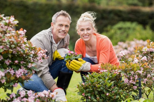 Hainault gardener wearing PPE while carrying out outdoor maintenance